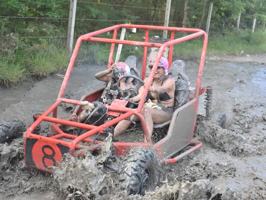 Dune buggy crossing a deep mud pit on excursion