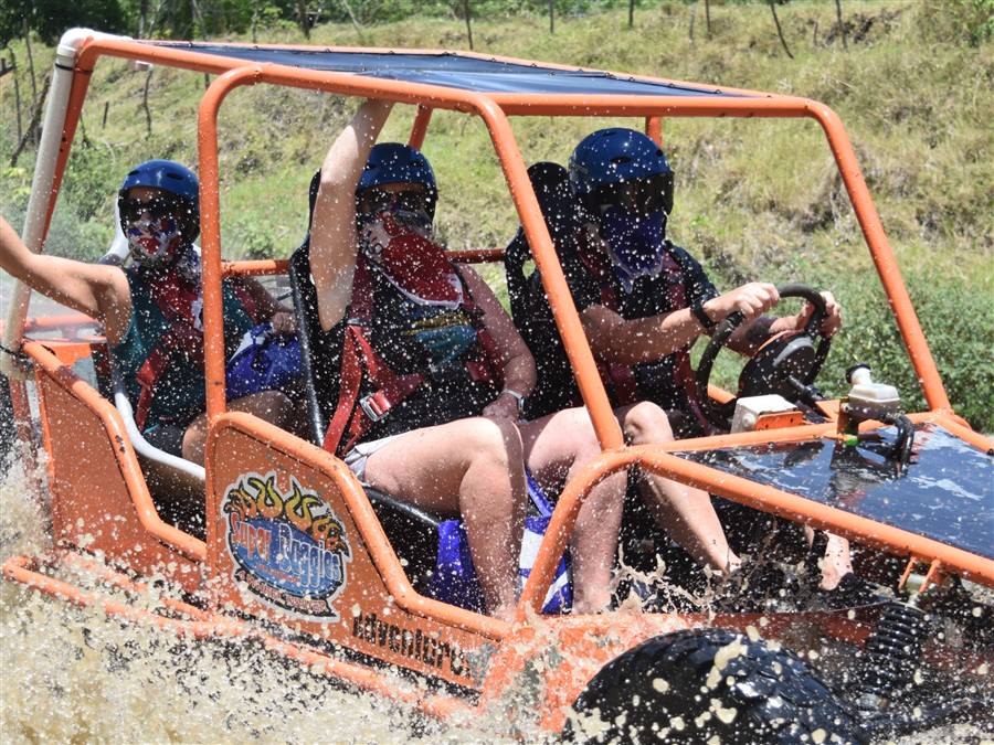 Dune buggy splashing through mud on a countryside excursion near Sosúa