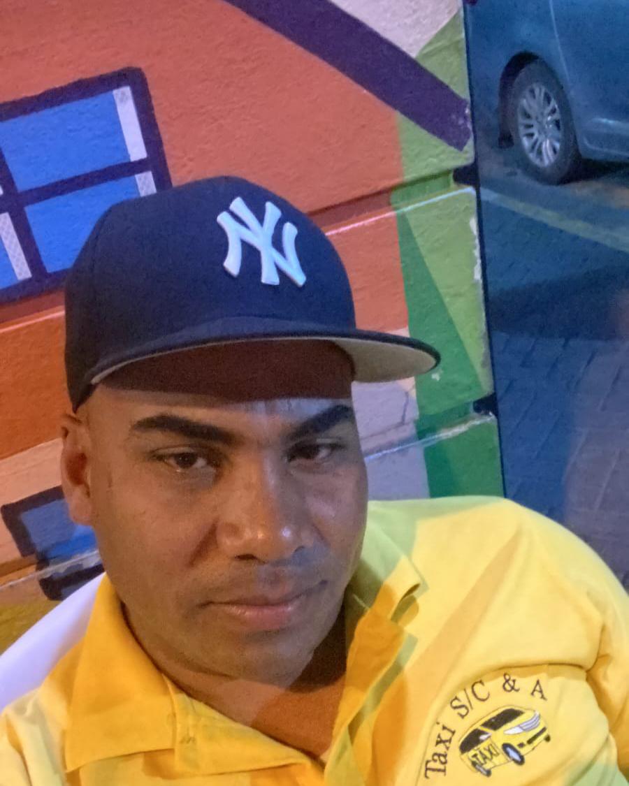 Junior Martinez beside his vehicle in Sosúa, Dominican Republic